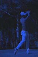 golf player hitting long shot photo