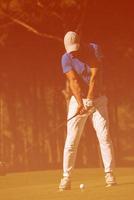 golf player hitting shot photo