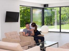 couple relaxing at  home with tablet computers photo