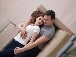 young handsome couple hugging on the sofa photo