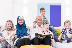 modern muslim grandparents with grandchildren reading Quran photo