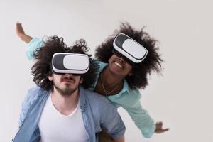 multiethnic couple getting experience using VR headset glasses photo