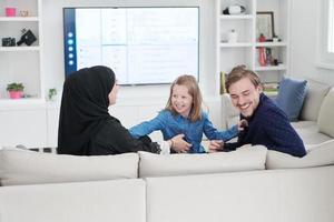 Happy Muslim family having fun at home photo