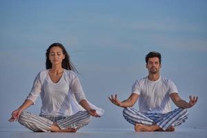 young couple practicing yoga photo