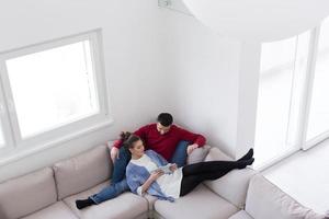 couple relaxing at  home with tablet computers photo