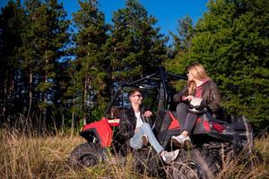 young couple driving a off road buggy car photo