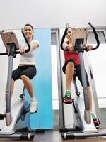 womanworkout  in fitness club on running track machine photo