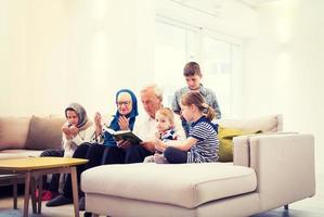 modern muslim grandparents with grandchildren reading Quran photo