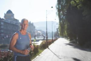 portrait of handsome senior jogging man photo