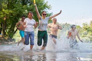 group of happy friends having fun on river photo