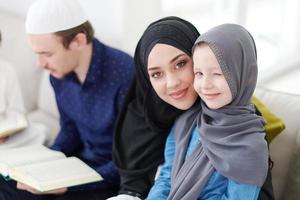 muslim family reading Quran and praying at home photo