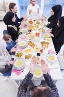 traditional muslim family praying before iftar dinner photo