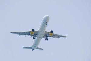 commercial aircraft flying under blue skies and arriving at the airport photo