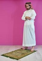 Young muslim man praying salat during Ramadan photo