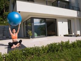 woman doing exercise with pilates ball photo