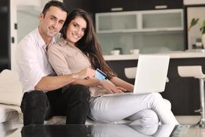 joyful couple relax and work on laptop computer at modern home photo