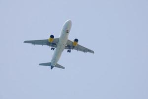 commercial aircraft flying under blue skies and arriving at the airport photo