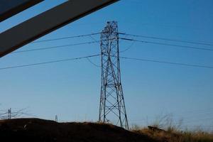 metallic electric towers supporting copper cables for transporting electricity photo