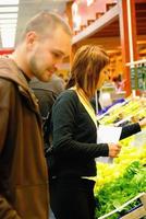 happy couple buying fruits in hypermarket photo