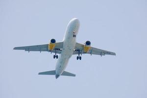 commercial aircraft flying under blue skies and arriving at the airport photo