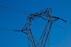 metallic electric towers supporting copper cables for transporting electricity photo