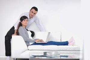 joyful couple relax and work on laptop computer at modern home photo