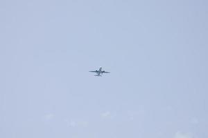 commercial aircraft flying under blue skies and arriving at the airport photo