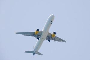 commercial aircraft flying under blue skies and arriving at the airport photo