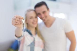 couple showing a keys of their new house photo