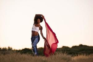 black girl dances outdoors in a meadow photo