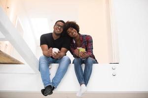 couple having break during moving to new house photo