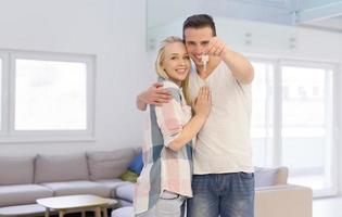 couple showing a keys of their new house photo