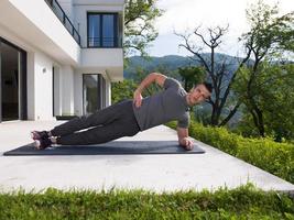 man doing morning yoga exercises photo