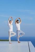 young couple practicing yoga photo