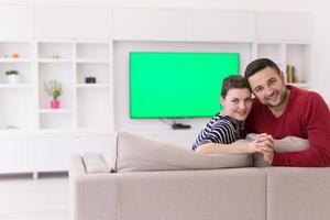 couple hugging and relaxing on sofa photo