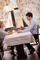 young couple having dinner at a restaurant photo