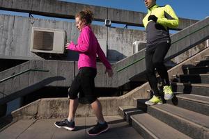 young  couple jogging on steps photo