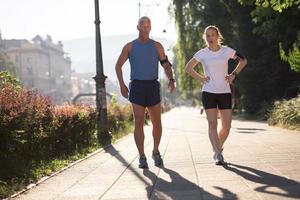 jogging couple planning running route  and setting music photo