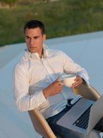 relaxed young man at home on balcony photo