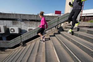 young  couple jogging on steps photo