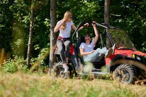 couple enjoying beautiful sunny day while driving a off road buggy photo