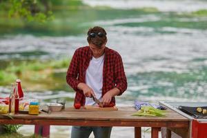 man cooking tasty food for french dinner party photo