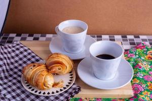 cup of coffee and croissant photo