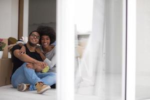 African American couple relaxing in new house photo