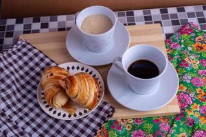 cup of coffee and croissant photo