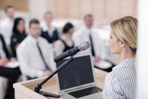 business woman standing with her staff at conference photo