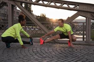 jogging couple warming up and stretching in the city photo