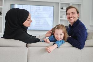 Happy Muslim family spending time together in modern home photo