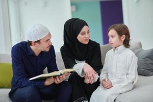 Young muslim family reading Quran during Ramadan photo