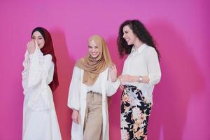 muslim women in fashionable dress isolated on pink photo